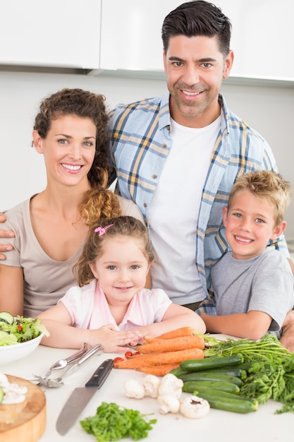 Família sorridente preparando vegetais juntos