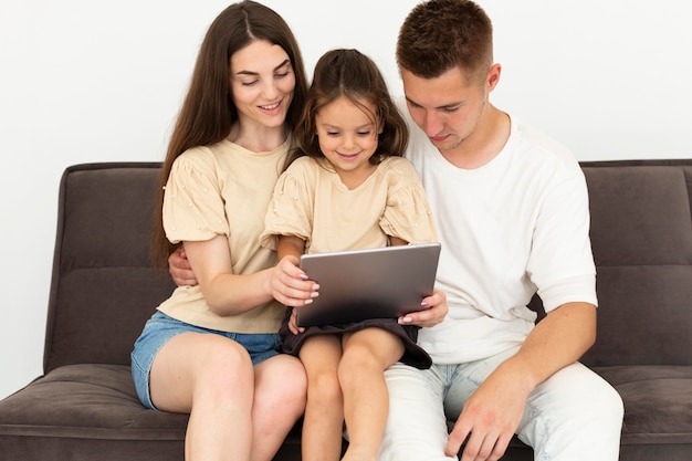 Foto família verificando um tablet juntos