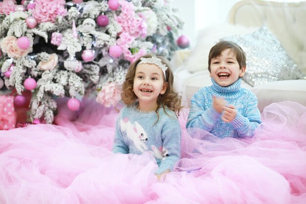 Familie, die schönen Live-Weihnachtsbaum schmückt. Liebevolle Familie mit Geschenken im Zimmer. Glückliche Familie im Urlaub.