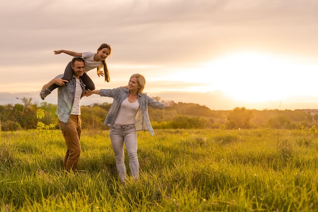 Familie geht auf einem Feld spazieren.