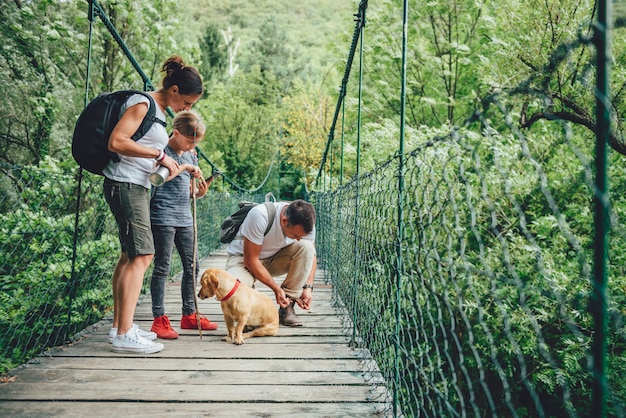 Familie mit dem Hund, der im Wald wandert