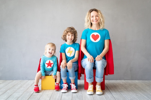 Foto familie von superhelden, die zu hause spielen