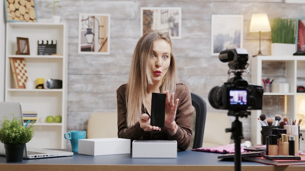 Famosa influenciadora de beleza gravando um vídeo de unboxing para seu vlog. Criador de conteúdo criativo.