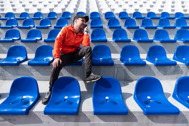 Los fanáticos del fútbol aplauden en el podio del estadio, un solo fanático en el estadio está alentando a su favorito