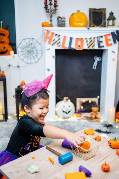 Fantasia infantil para o festival de Halloween em casa. Celebração em família e quarto decorado no outono.