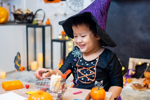 Fantasia infantil para o festival de Halloween em casa. Celebração em família e quarto decorado no outono.