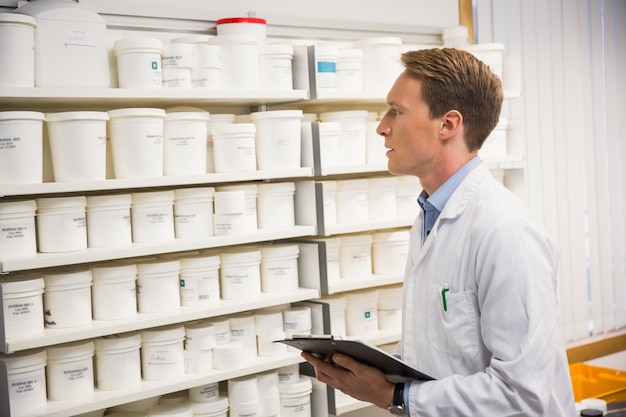 Foto farmacêutico bonito olhando medicamento