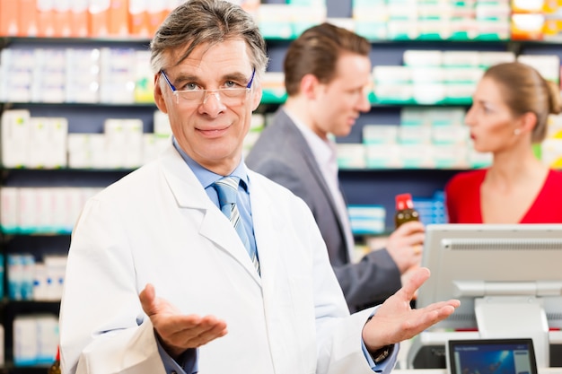 Farmacéutico con clientes en farmacia