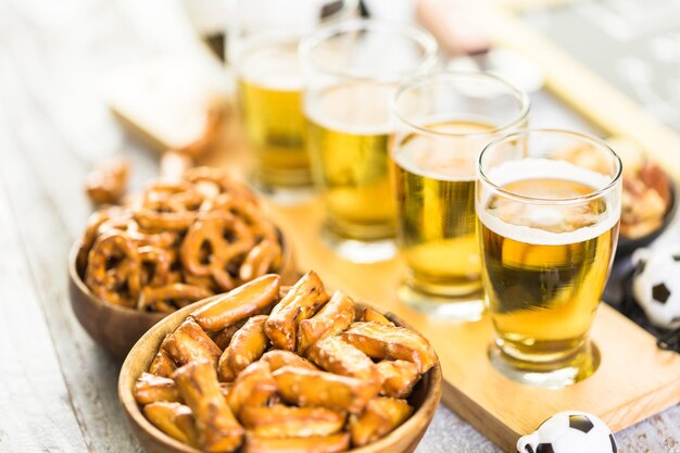 Fassbier und salzige Snacks auf dem Tisch für die Fußballparty.