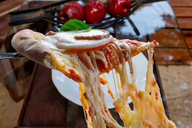 Fatia de pizza quente com queijo derretido