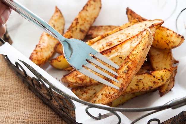 Fatias de batata assada na cesta - vegetais orgânicos caseiros, batata vegan cunhas refeição de lanche