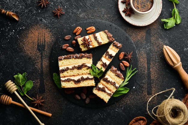 Fatias de bolo de chocolate cremoso doce. sobremesa. em um fundo preto. vista do topo.