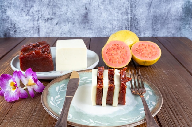 Fatias de doce de goiaba e requeijão ao lado de uma faca de cobre e vista de garfo