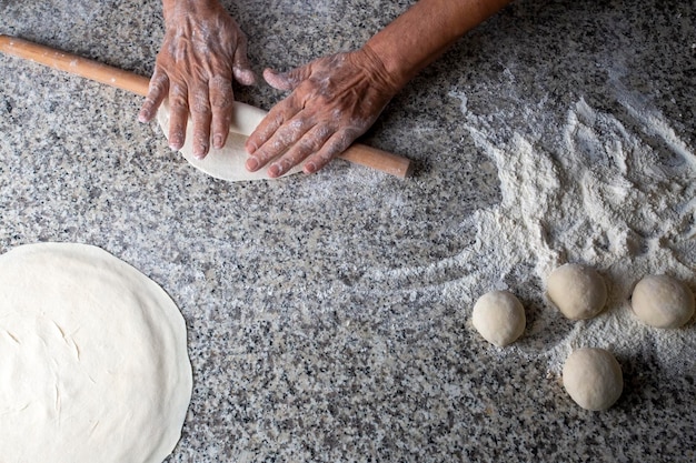 Foto fazendo pão com um rolo de massa de fermento estilo turco