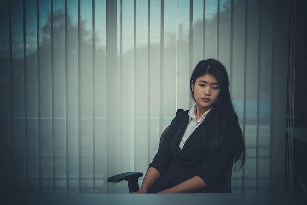 Feche a mulher triste na estressada do escritório do trabalho durodesgosto do namoradotailândia