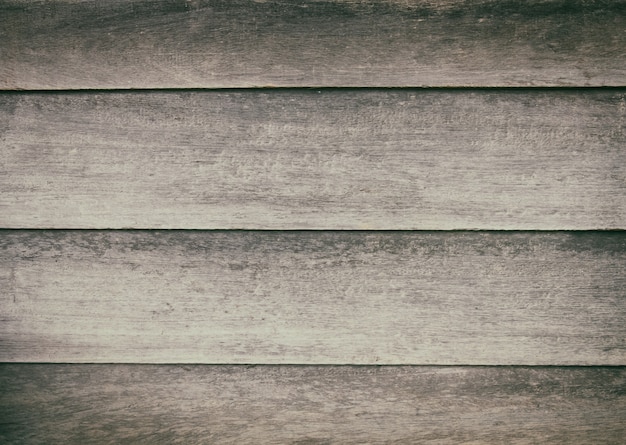 Feche acima da superfície de madeira rústica da tabela com textura da grão no estilo do vintage.