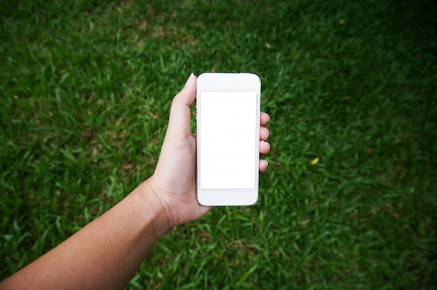 Feche acima das mãos das mulheres segurando a tela do espaço de cópia em branco do telefone celular. telefone inteligente com conceito de tecnologia.