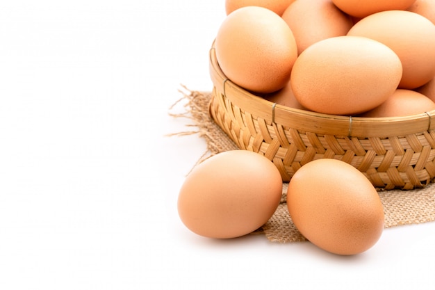 Feche acima dos ovos frescos isolados no branco.
