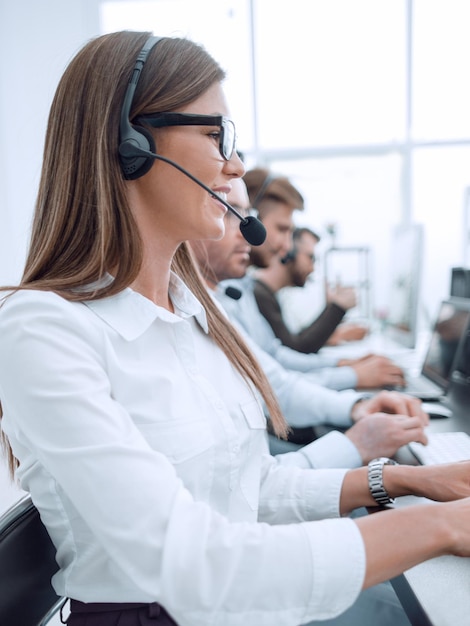 Feche o funcionário do call center no fundo de seus colegas o conceito de profissionalismo