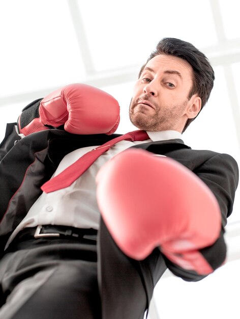 Foto feche um empresário sério em luvas de boxe vermelhas