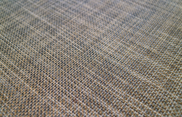 Fechou o padrão de cesta-weave diagonal de um tapete de almoço para o fundo