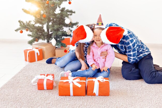 Feiertage und festliches Konzept - Glückliches Familienporträt am Weihnachtsbaum.