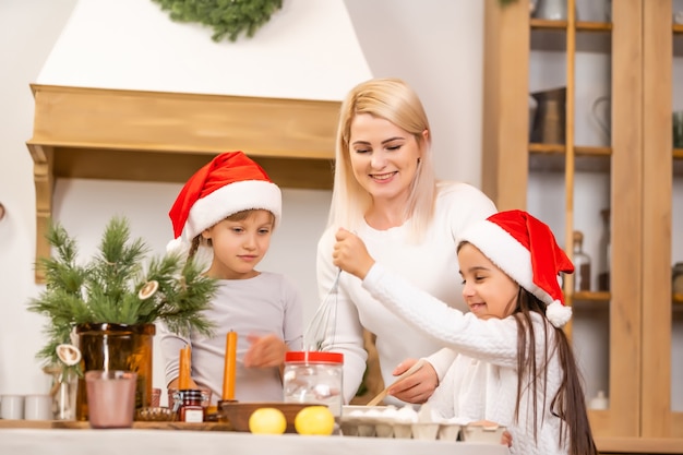 Feiertags-, Familien- und Feierkonzept - glückliche Mutter, Vater und kleine Tochter beim Weihnachtsessen zu Hause