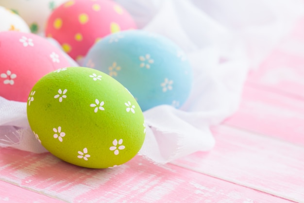 ¡Felices Pascuas! Colorido de huevos de Pascua en nido blanco
