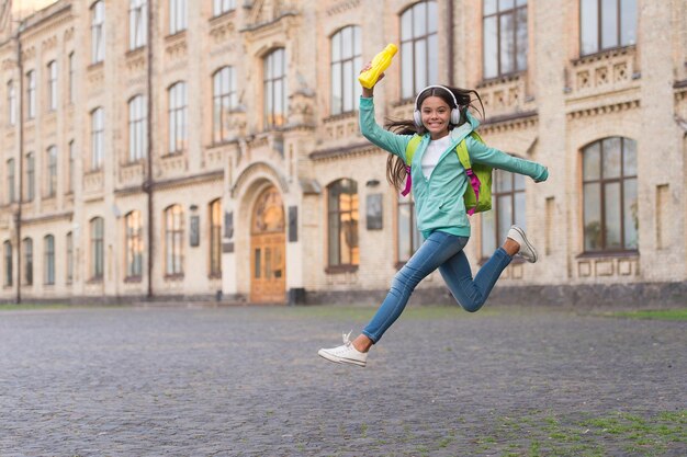 Felicidade da infância. ativo e despreocupado. criança feliz pular em fones de ouvido. de volta à escola. adolescente segura garrafa de esporte. equilíbrio de água no corpo. hora do almoço. hidratação da saúde. estilo de vida saudável.