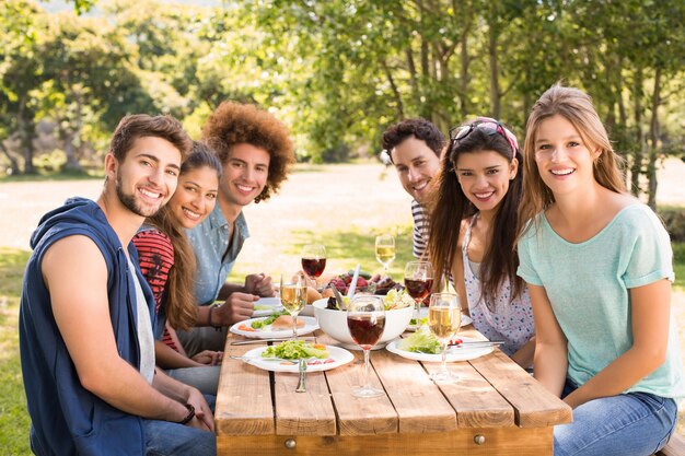 Feliz amigos no parque almoçando