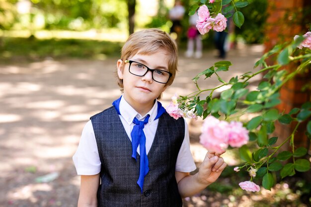 Feliz colegial con gafas y corbata azul