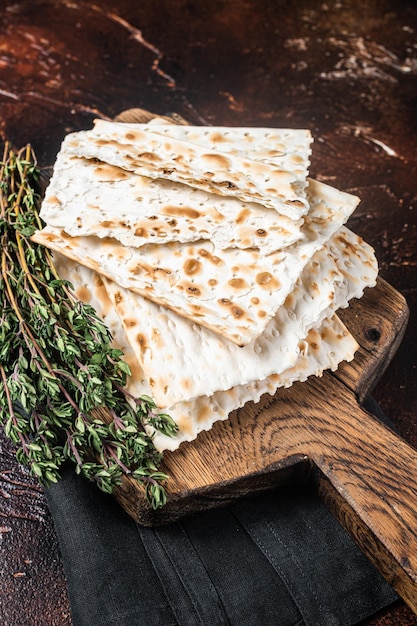 Feliz concepto de Pascua matzá en una tabla de madera Fondo oscuro Vista superior