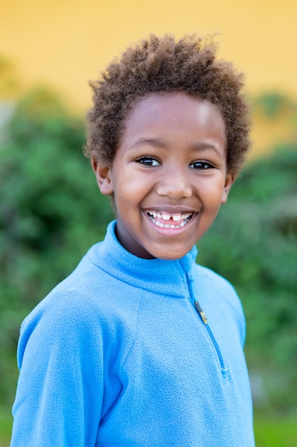 Feliz criança africana com camisa azul