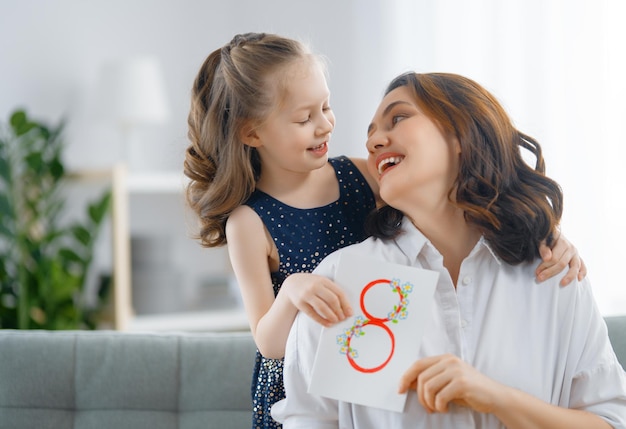 Feliz dia internacional da mulher filha filha está parabenizando a mãe e dando seu cartão postal