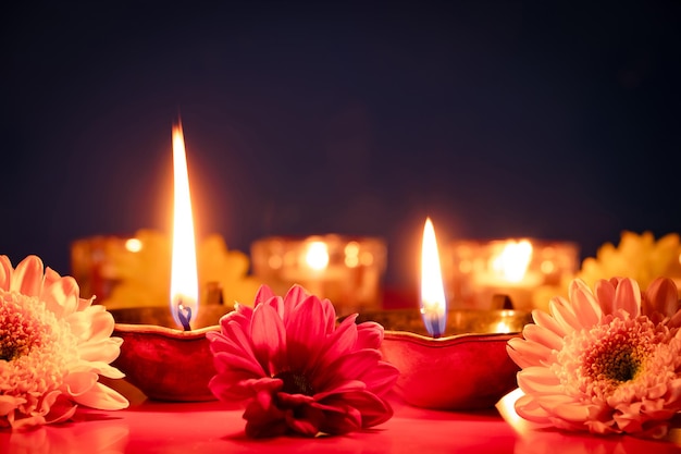 Feliz Diwali Quemando lámparas de aceite diya y flores sobre fondo azul Festival tradicional indio de la luz