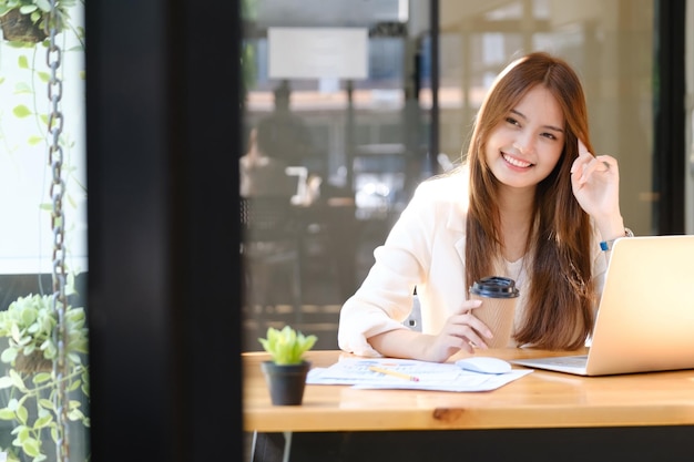 Feliz empresária relaxando na mesa de escritório