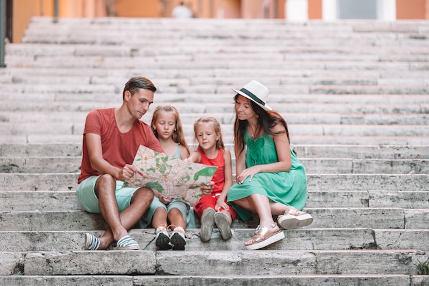 Feliz familia de cuatro en Roma con mapa