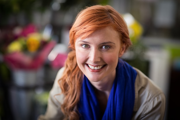 Feliz florista feminina na loja de flores