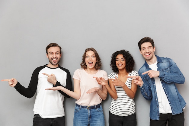 Foto feliz grupo de amigos apontando.