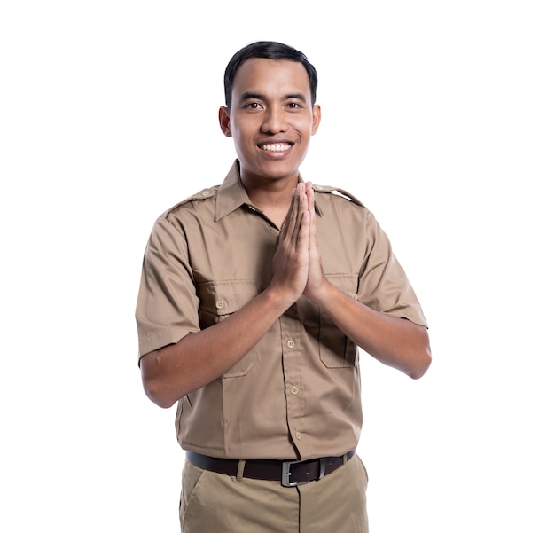 Feliz hombre asiático vistiendo un uniforme de color caqui orando