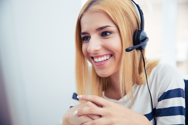 Feliz joven operador en auriculares