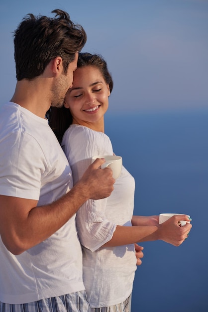 feliz joven pareja romántica diviértete relájate sonríe en casa moderna terraza al aire libre balcón terraza