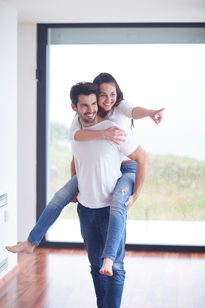 feliz joven pareja romántica diviértete relájate sonríe en el moderno interior de la sala de estar