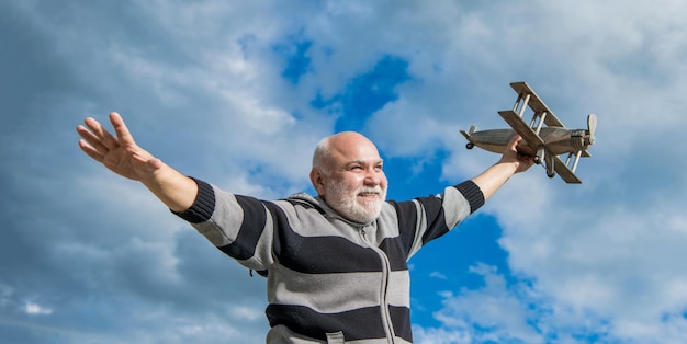 Feliz jubilación abuelo alegre con juguete jubilado anciano senior al aire libre en la jubilación