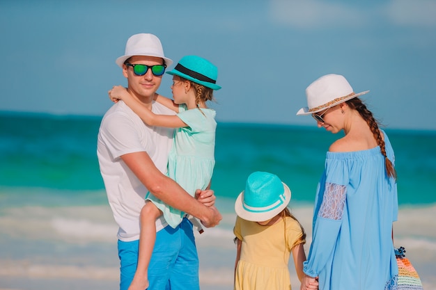 Feliz linda família de quatro na praia branca