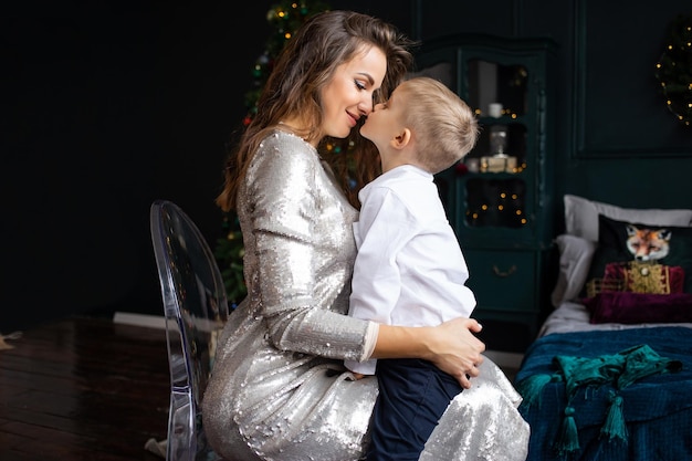 Feliz madre e hijo en casa decorada para Navidad Madre y niño en casa Navidad Año Nuevo invierno y temporadas de vacaciones concepto Familia