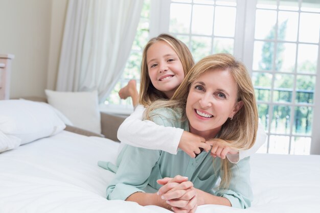 Feliz mãe e filha sorrindo na câmera