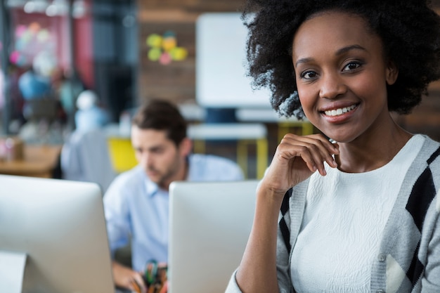 Feliz mujer de pie en la oficina