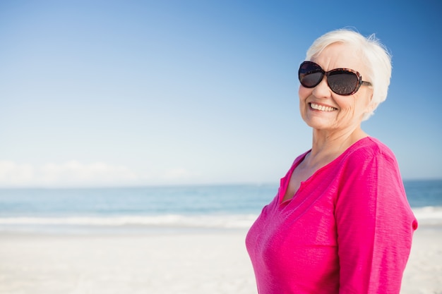 Feliz mujer senior con gafas de sol sonriendo