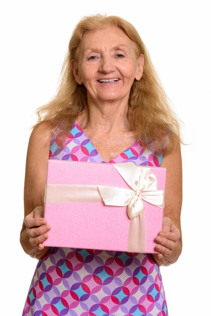 feliz mujer senior sonriendo y sosteniendo la caja de regalo